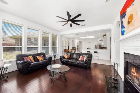 a living room with fireplace furniture and a wooden floor