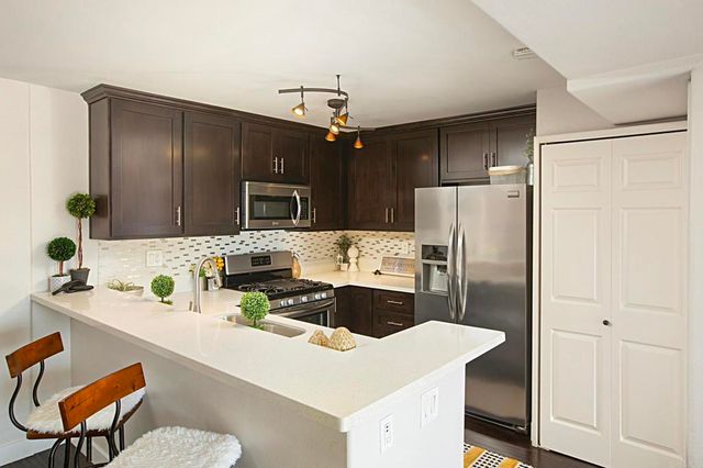 a kitchen with a refrigerator and a sink