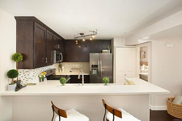 a dining room with furniture and a potted plant