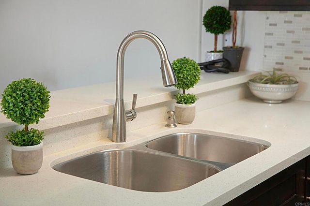 a close view of a sink and a potted plant