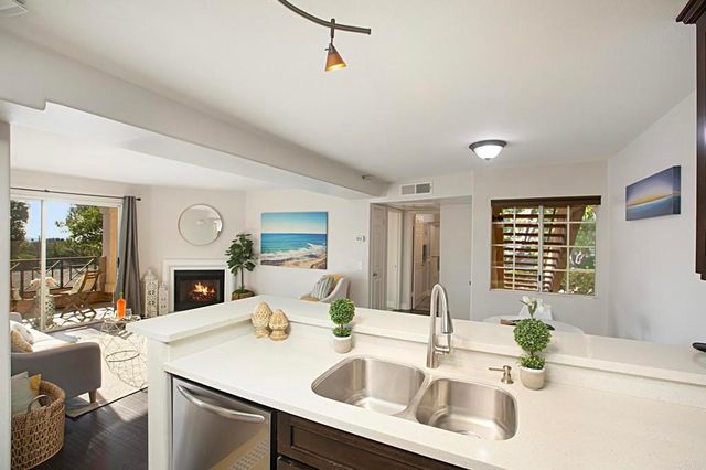a view of kitchen with a sink and living room