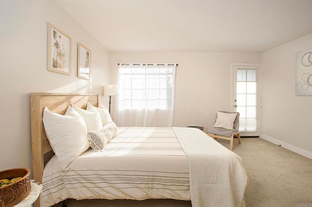 a bedroom with a bed and chair