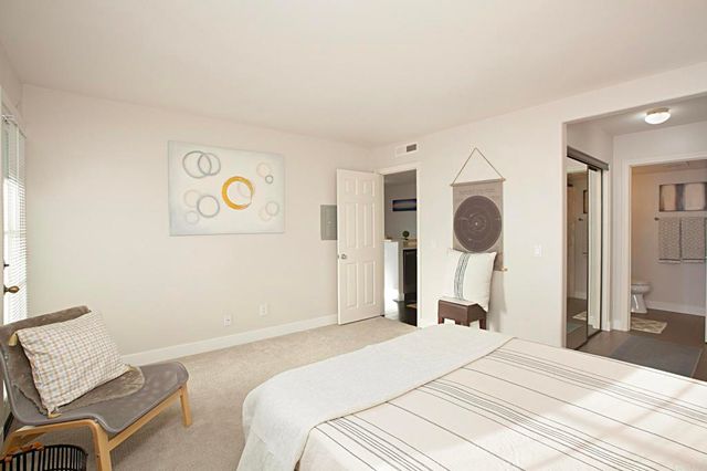 a bedroom with a bed and cabinets