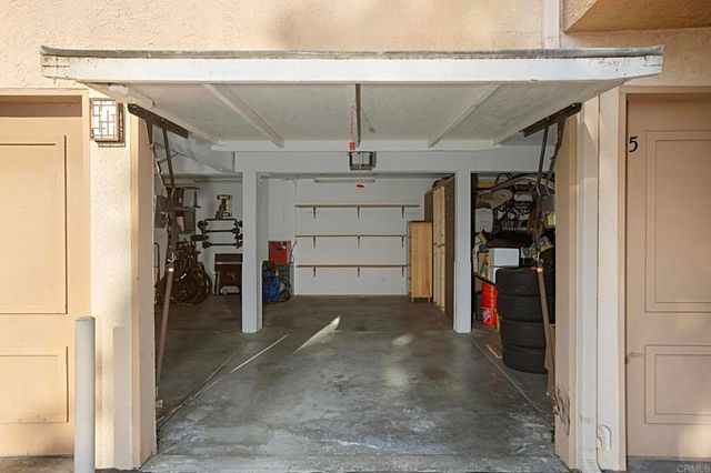 a room with gym equipment and large windows