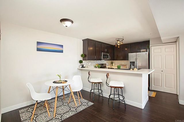 a kitchen with stainless steel appliances kitchen island granite countertop a sink and cabinets