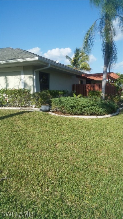 2081 Matecumbe Key Road, Unit 4 Punta Gorda, FL 33955 - Photo 3 of 12 a front view of a house with a yard