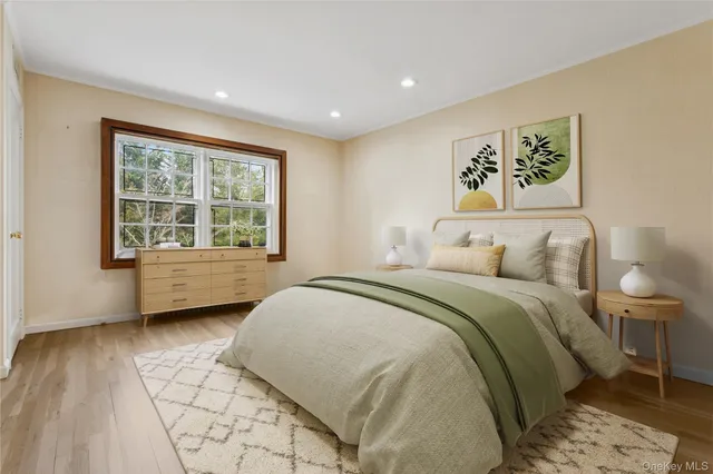 a spacious bedroom with a bed and a window