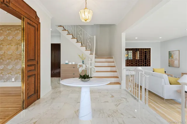 a view of entryway and hall with wooden floor