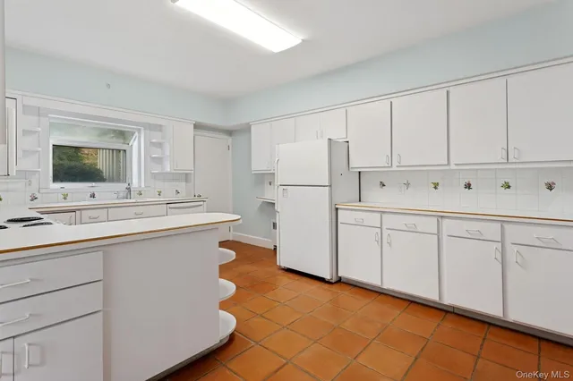 a kitchen with a sink cabinets and appliances