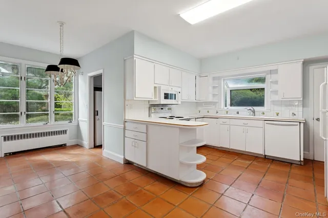 a kitchen with a sink window and cabinets