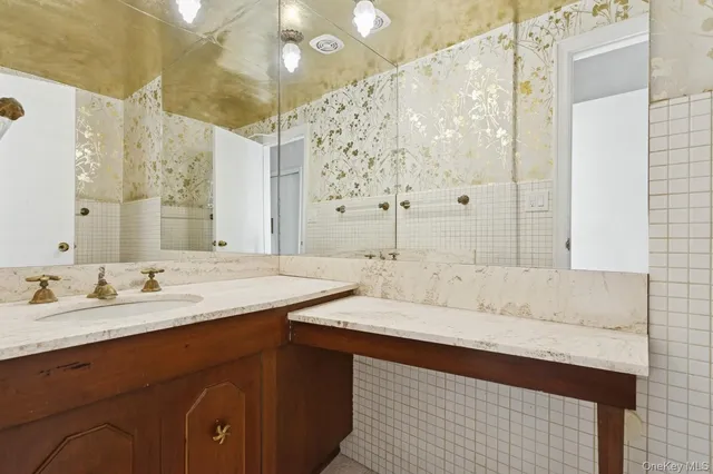 a bathroom with a double vanity sink mirror and shower