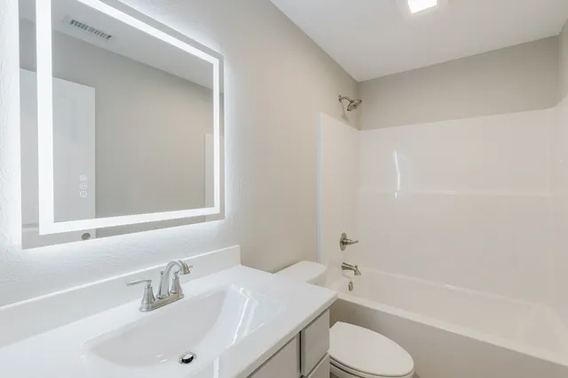a bathroom with a sink toilet and bathtub