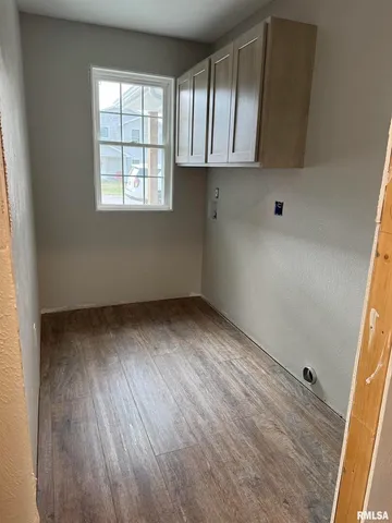 an empty room with wooden floor