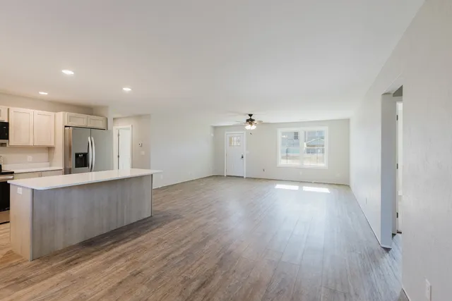 a view of kitchen with wooden floor and electronic appliances