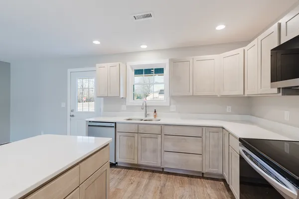 a kitchen with a sink stove and microwave