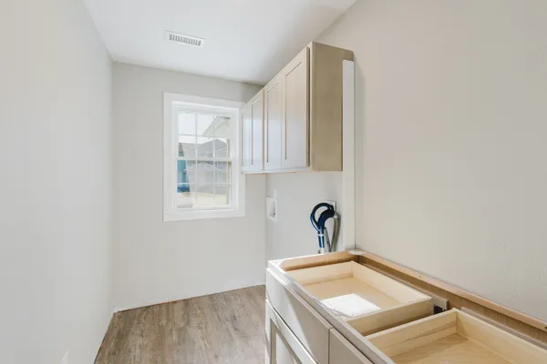 a room with a sink and cabinets