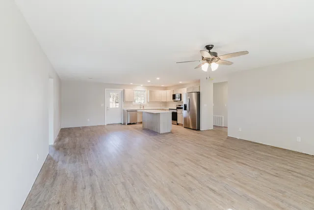 a view of a kitchen with a sink and a refrigerator