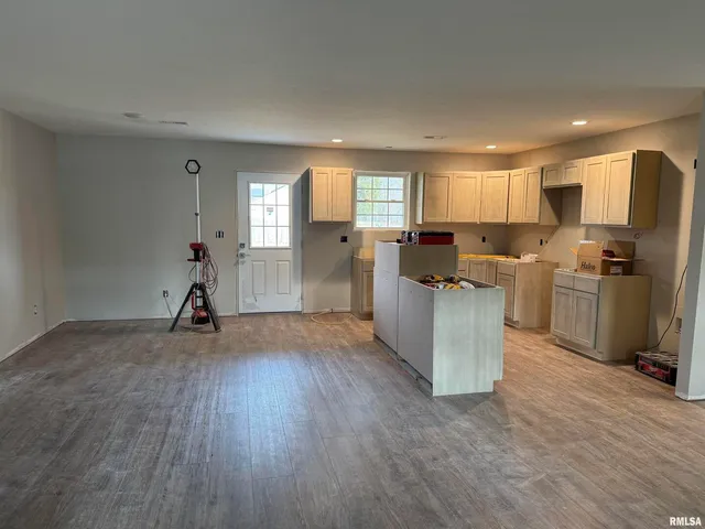 a view of a kitchen with refrigerator microwave and cabinets