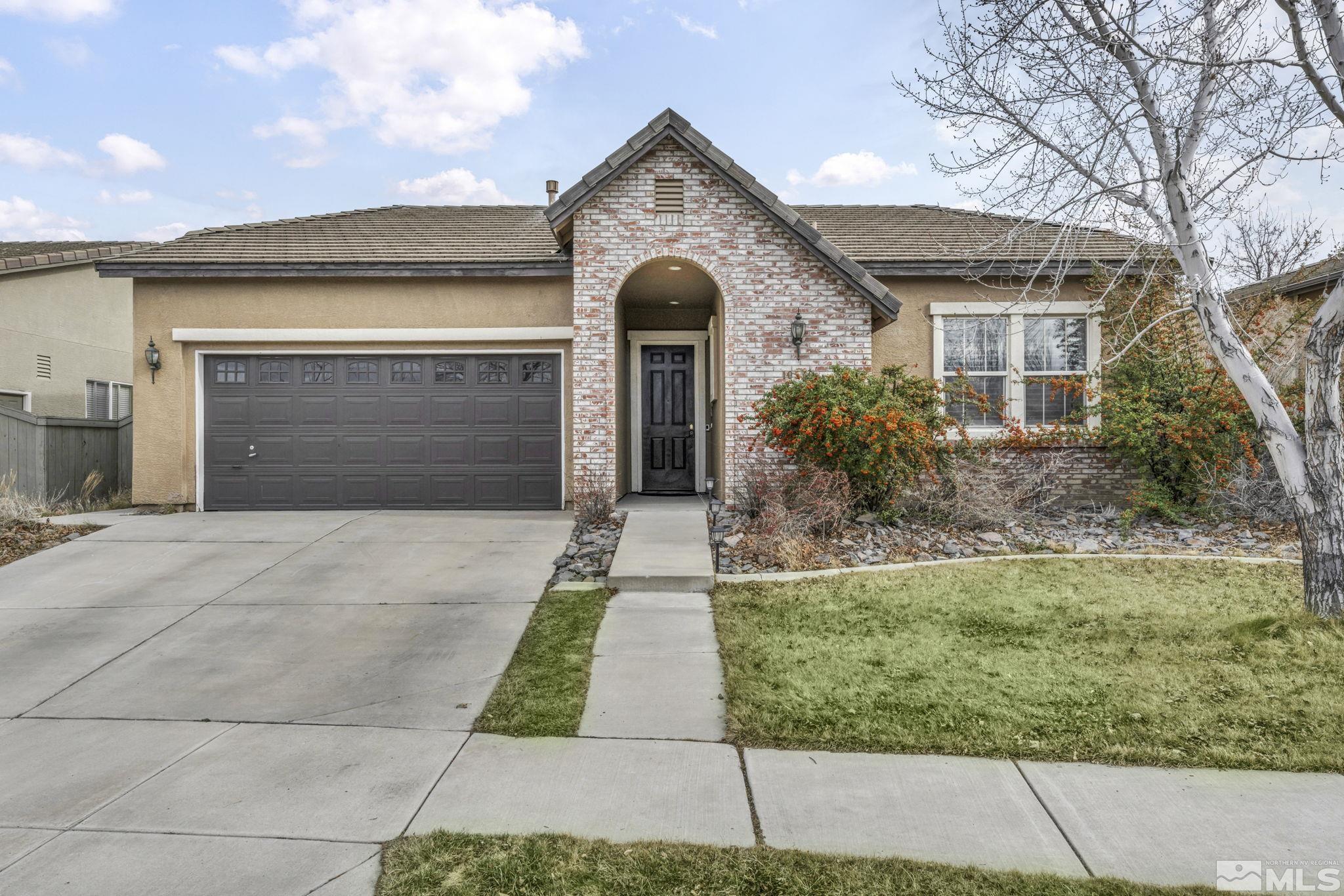 10518 French Meadows Way Reno, NV 89521 - Photo 1 of 34 a front view of a house with garden