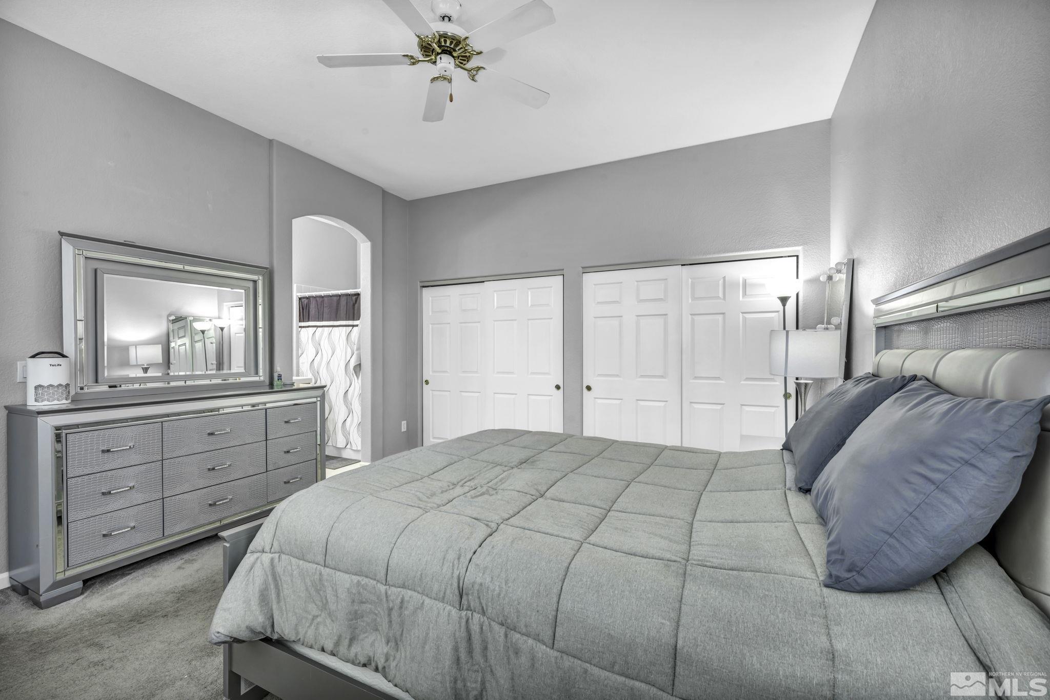 10518 French Meadows Way Reno, NV 89521 - Photo 13 of 34 a bedroom with a large bed and a chandelier