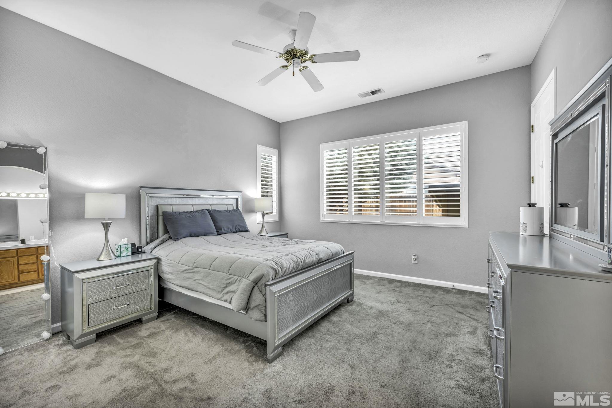 10518 French Meadows Way Reno, NV 89521 - Photo 14 of 34 a bed room with a bed and a chandelier