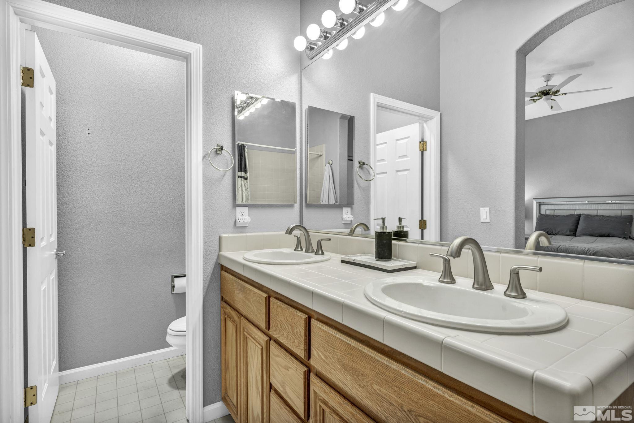10518 French Meadows Way Reno, NV 89521 - Photo 16 of 34 a bathroom with a sink and a mirror