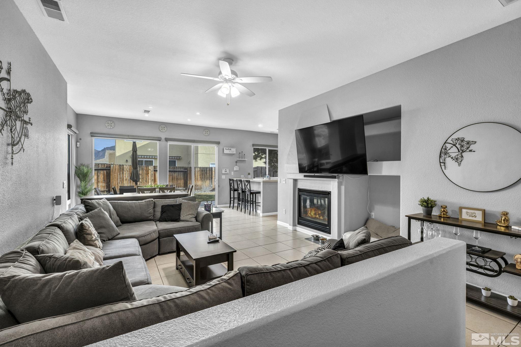 10518 French Meadows Way Reno, NV 89521 - Photo 23 of 34 a living room with furniture and a flat screen tv