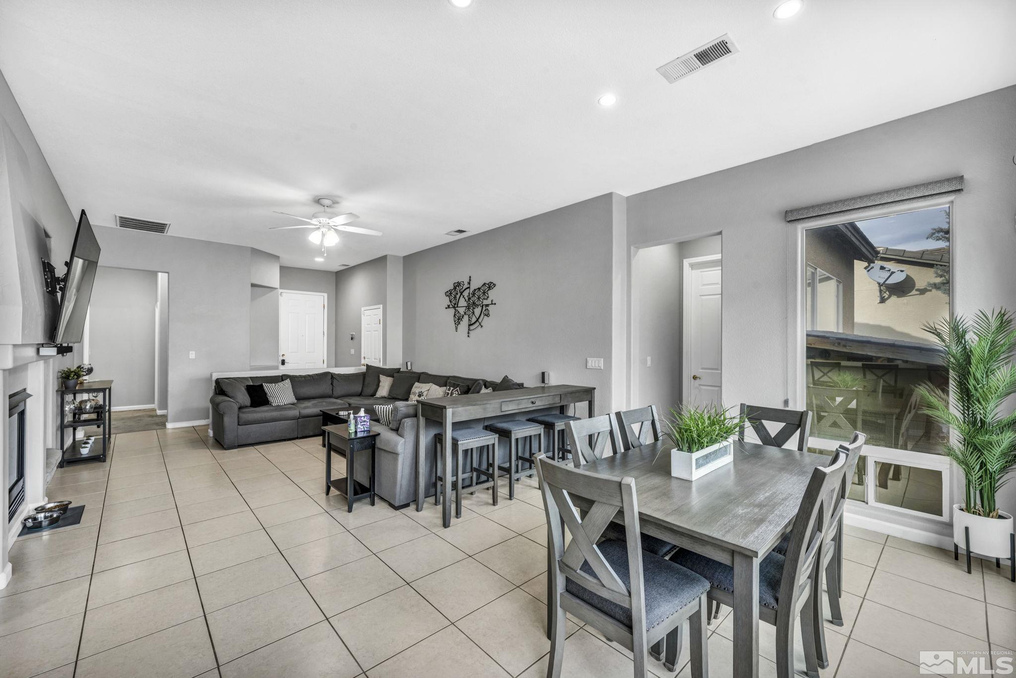 10518 French Meadows Way Reno, NV 89521 - Photo 26 of 34 a living room with lots of furniture and a dining table