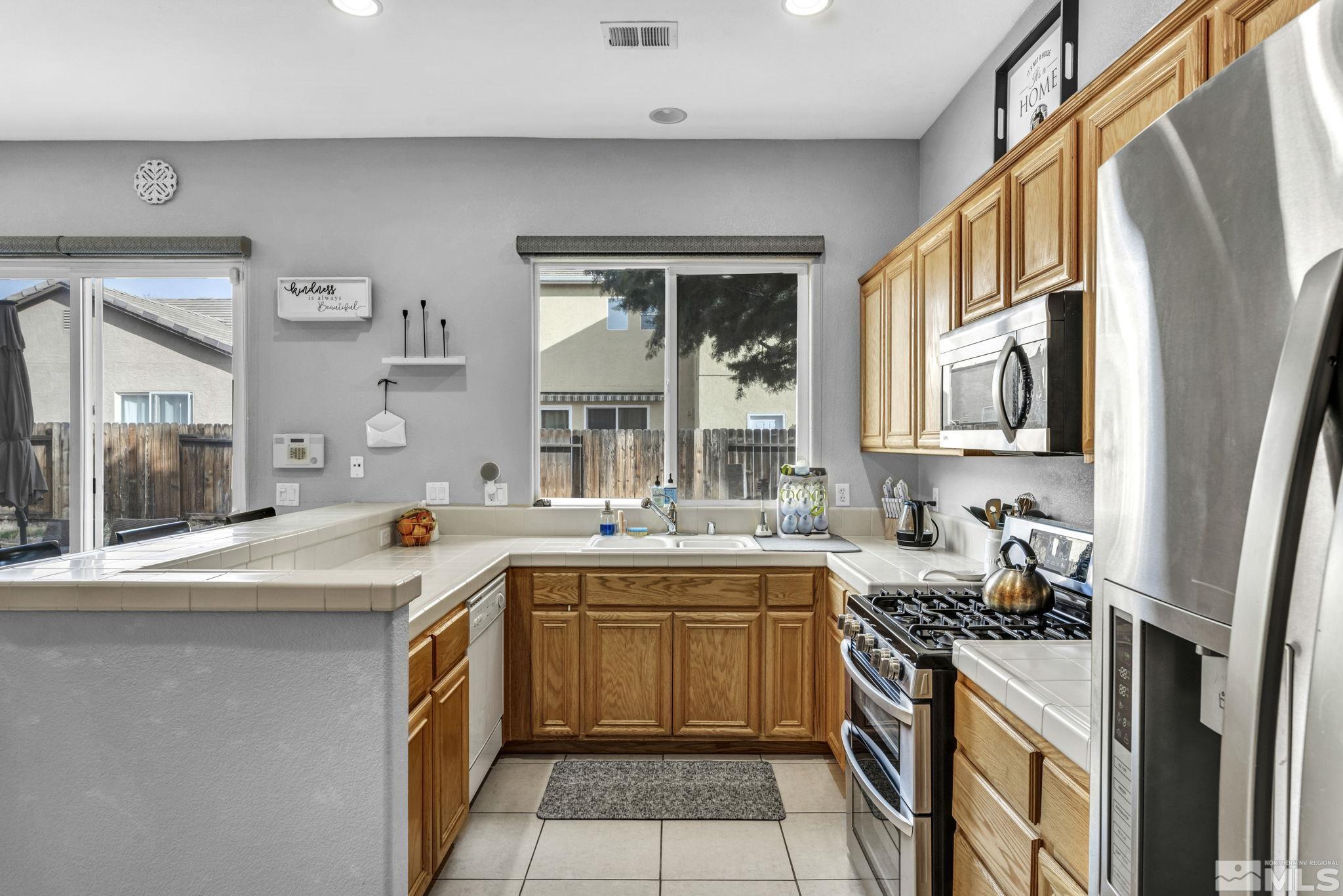 10518 French Meadows Way Reno, NV 89521 - Photo 33 of 34 a kitchen with a sink stove and cabinets