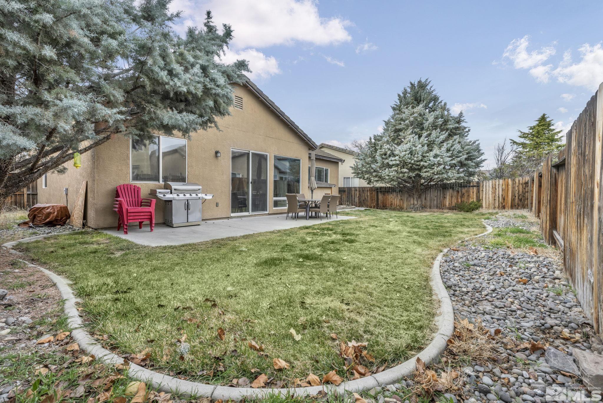 10518 French Meadows Way Reno, NV 89521 - Photo 4 of 34 a backyard of a house with table and chairs