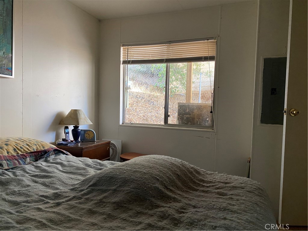 7360 Lassen Street Nice, CA 95464 - Photo 11 of 13 a bedroom with a bed and a window