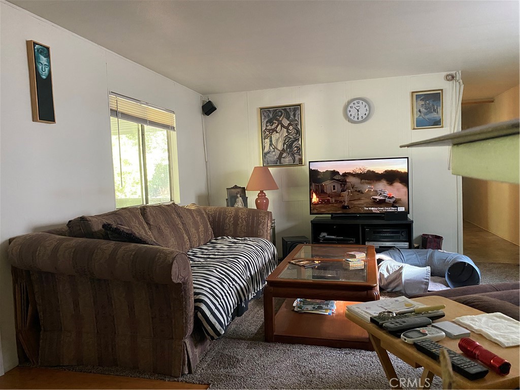7360 Lassen Street Nice, CA 95464 - Photo 4 of 13 a living room with furniture a flat screen tv and a window