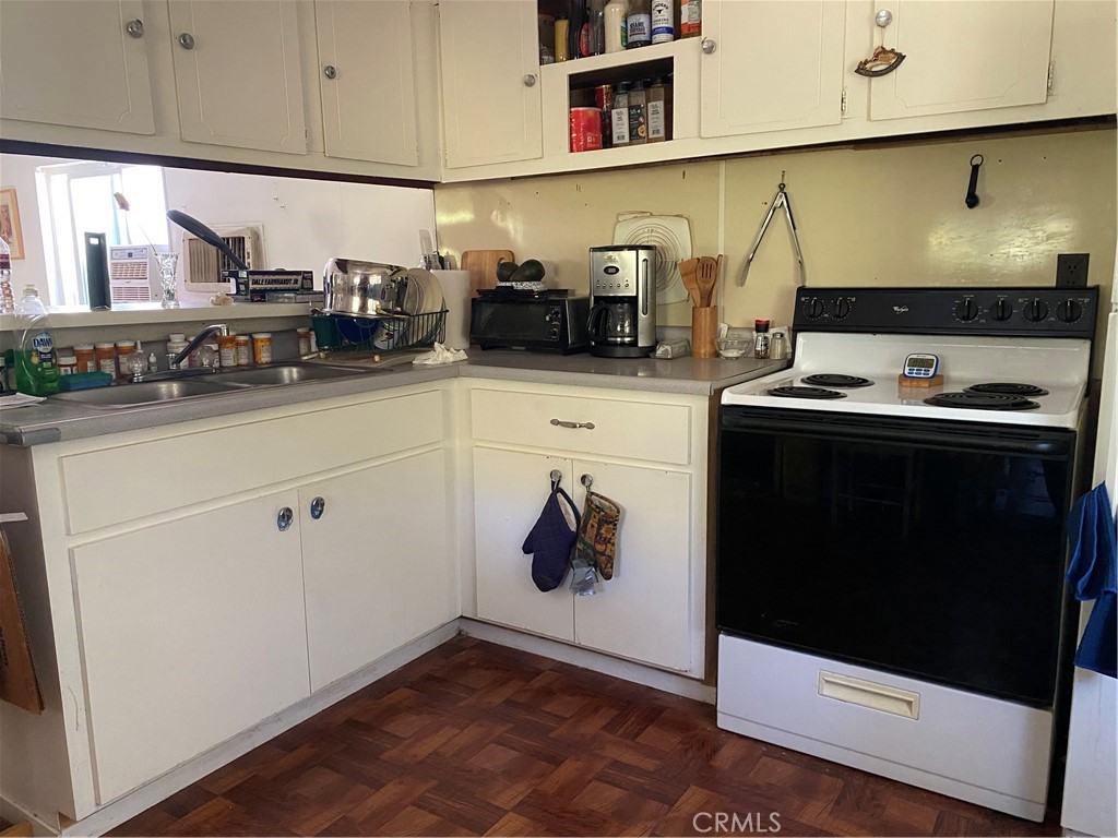 7360 Lassen Street Nice, CA 95464 - Photo 7 of 13 a kitchen with stainless steel appliances a stove a microwave and white cabinets
