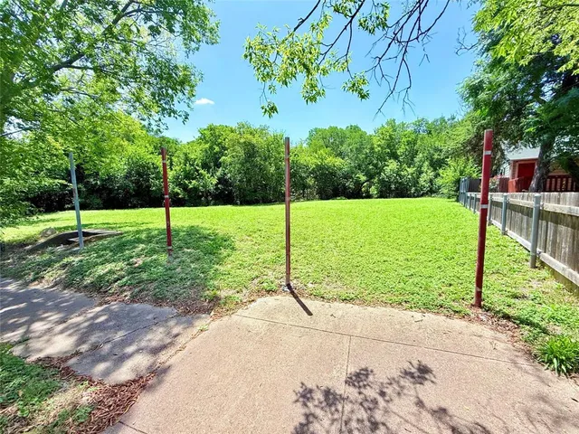 a view of a garden with a house in the background