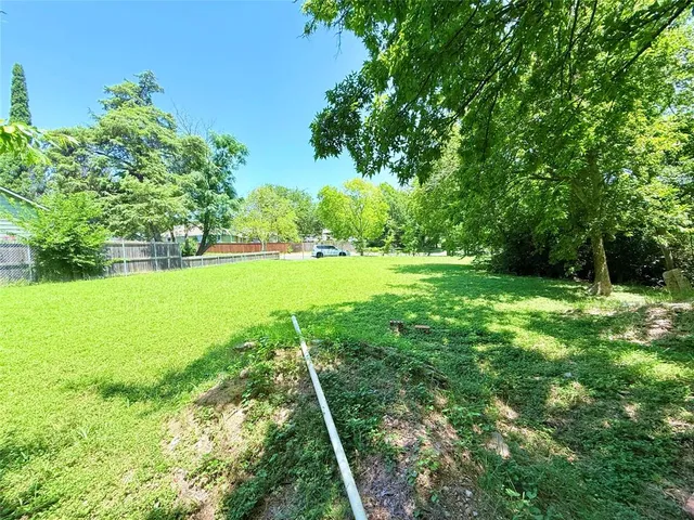 a view of field with trees in the background
