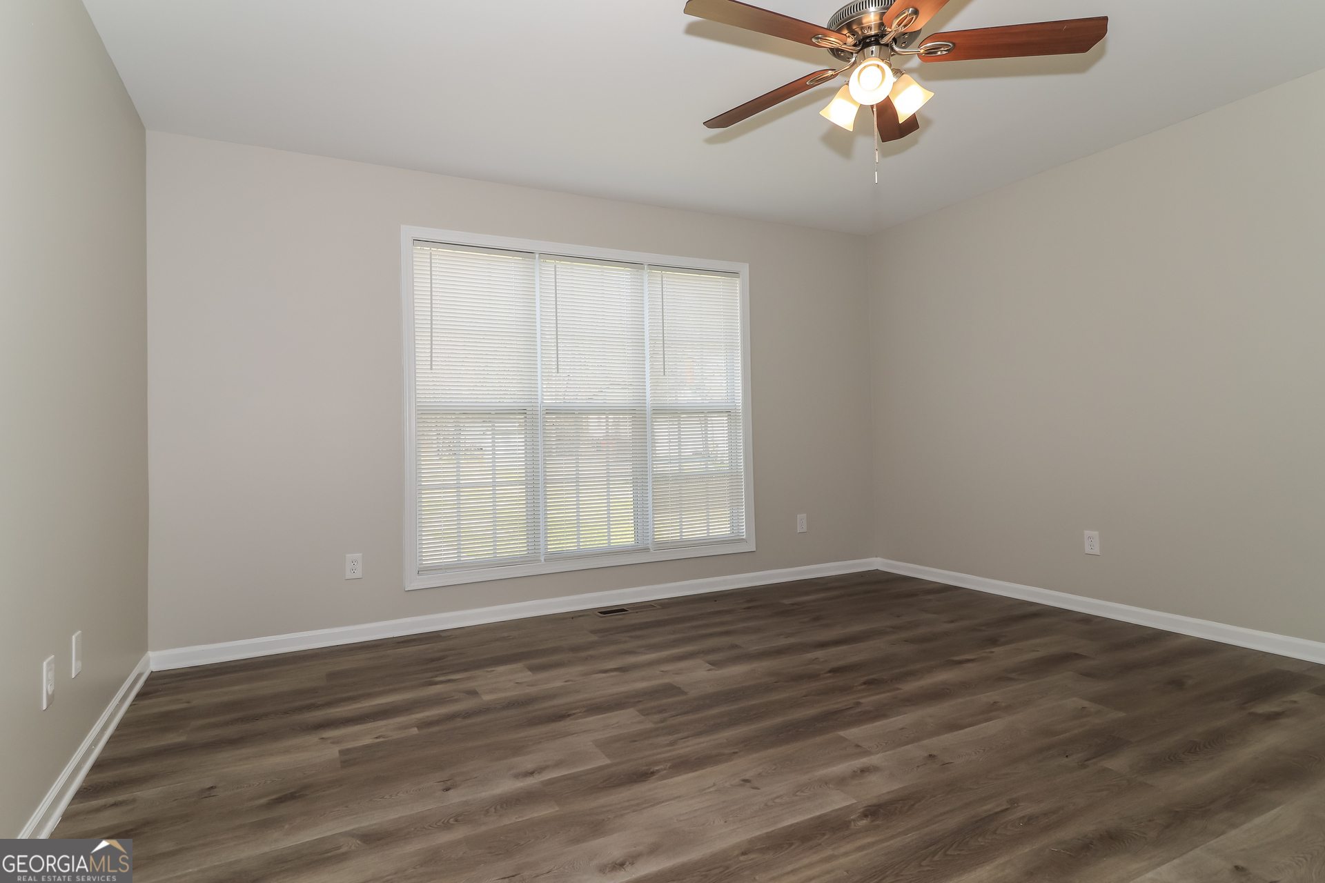 2 Wingfoot Trail Cartersville, GA 30120 - Photo 2 of 18 a view of an empty room with wooden floor and a window