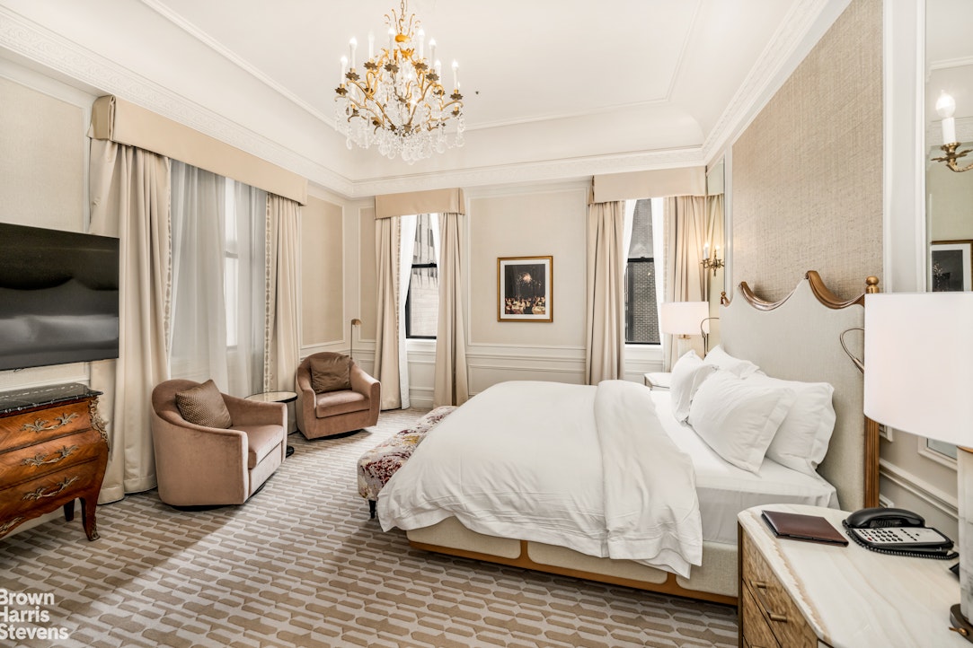 2 East 55th Street, Unit 835/31 Manhattan, NY 10022 - Photo 11 of 14 a bedroom with a bed and a couch