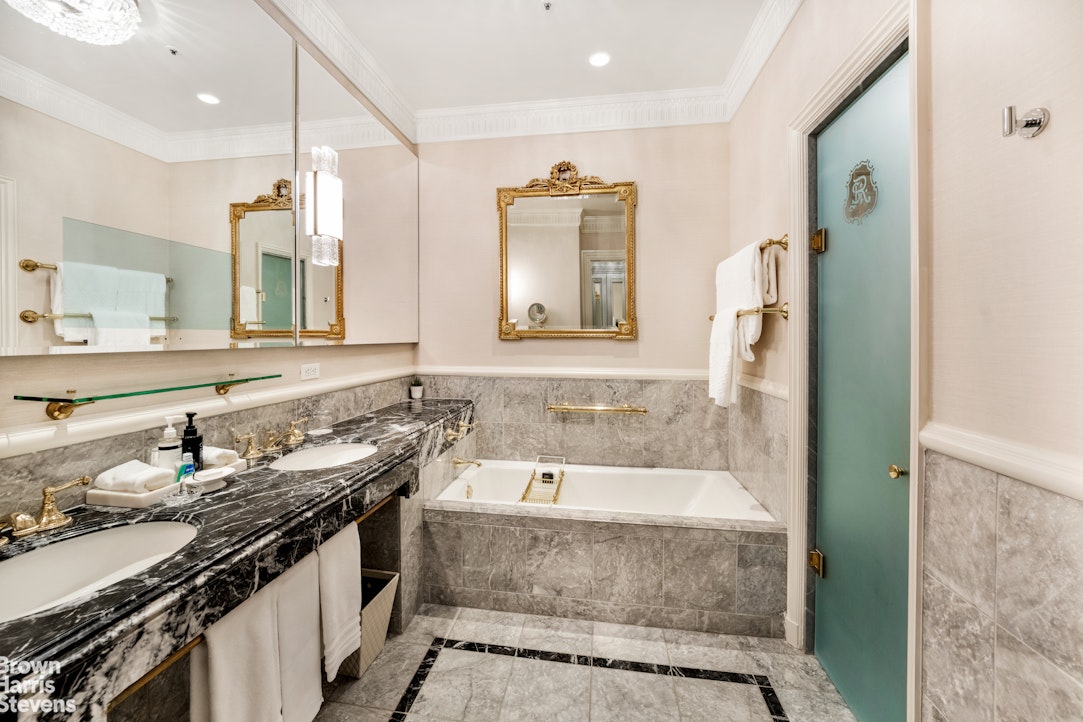 2 East 55th Street, Unit 835/31 Manhattan, NY 10022 - Photo 14 of 14 a bathroom with a granite countertop tub sink and mirror