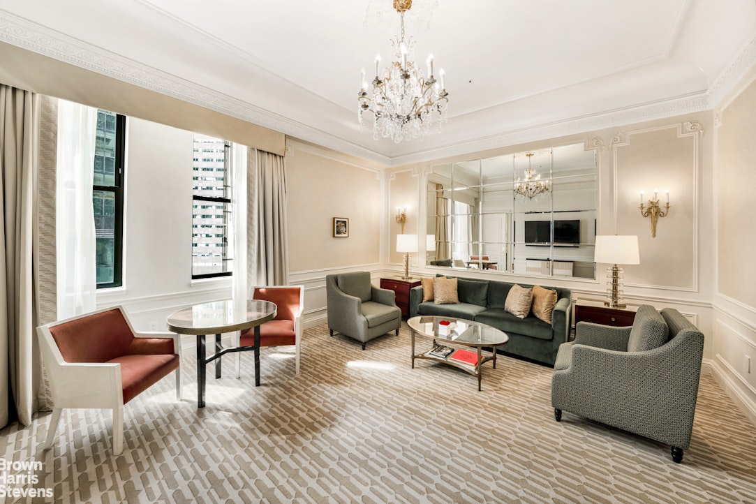 2 East 55th Street, Unit 835/31 Manhattan, NY 10022 - Photo 9 of 14 a living room with furniture and a chandelier