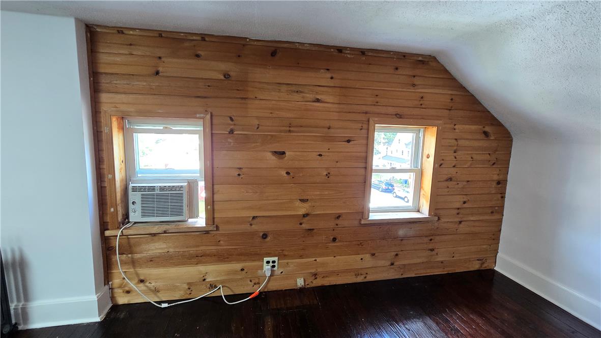 883 North Locust Street Hazleton, PA 18201 - Photo 65 of 83 A cozy attic space features warm wooden walls and glossy hardwood flooring.