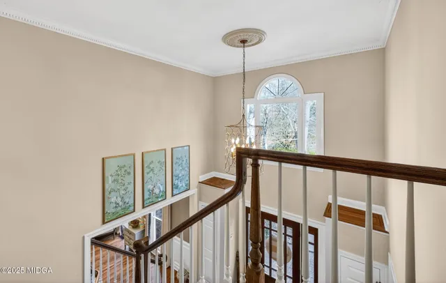 a view of entryway with wooden floor and stairs