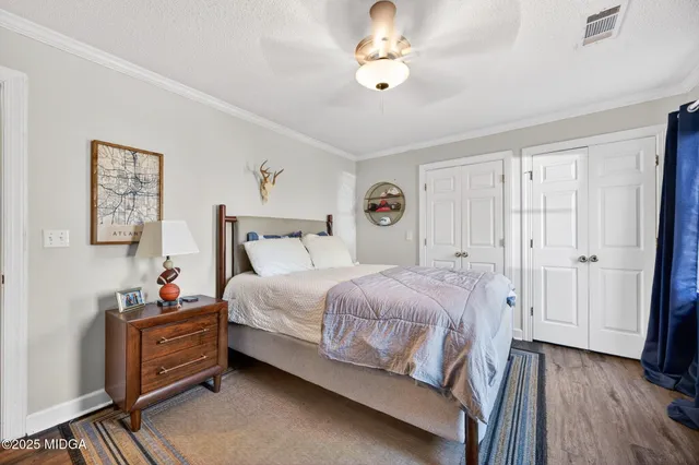 a bed room with a bed a dresser and a mirror