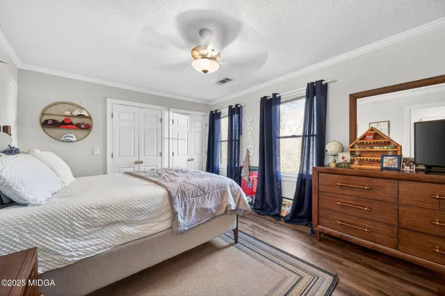 a bedroom with furniture window and wooden floor