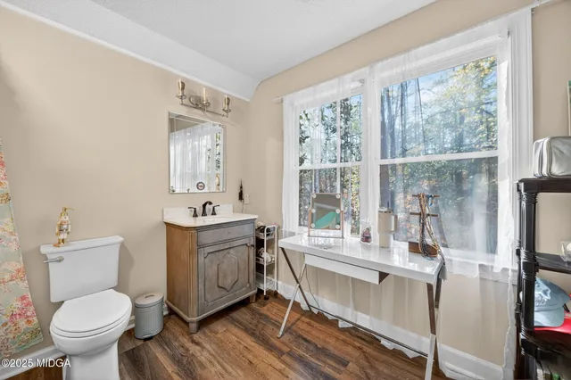 a living room with furniture a flat screen tv and a couch