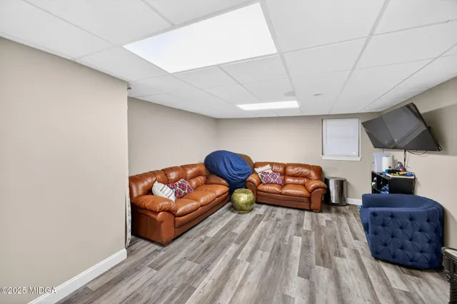 a bedroom with furniture and a wooden floor