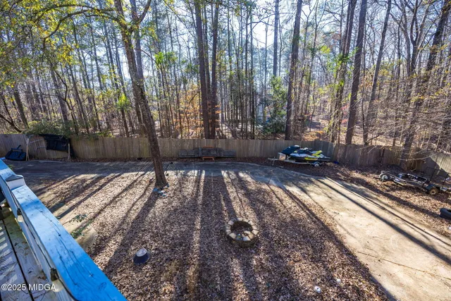 a front view of a house with yard and trees