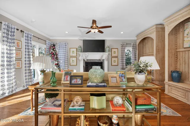 a living room with fireplace furniture and a flat screen tv