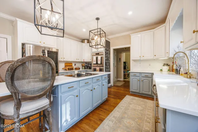a kitchen with cabinets a sink and appliances