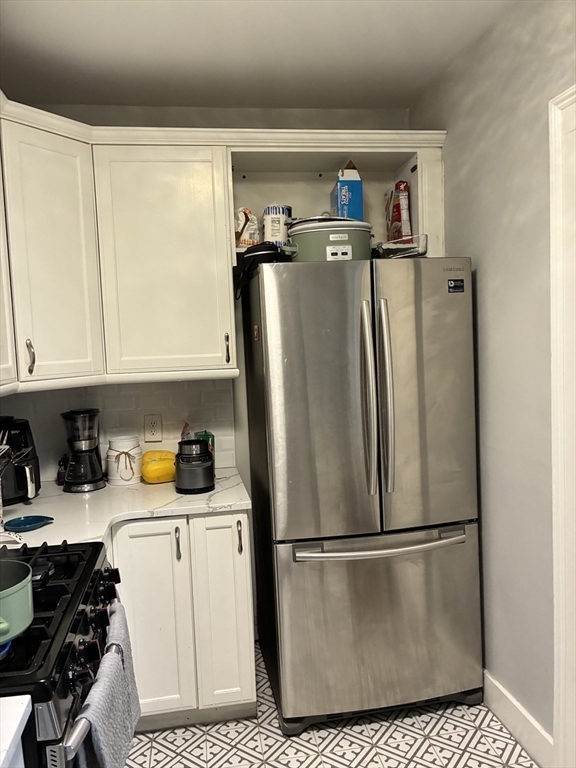 32 Shepard Street, Unit 24 Cambridge, MA 02138 - Photo 11 of 15 a white refrigerator freezer sitting in a kitchen