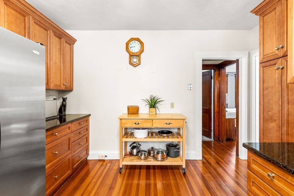 86 Howard Street, Unit 1 Waltham, MA 02451 - Photo 11 of 40 a kitchen with wooden floors and a sink